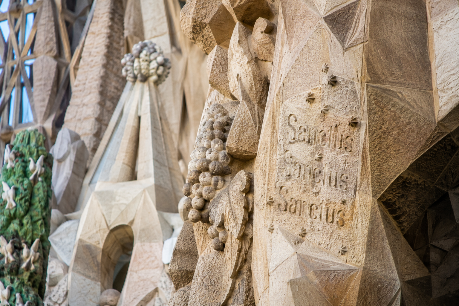 Close-up of carved stone details and religious symbolism on Sagrada Familia in Barcelona.