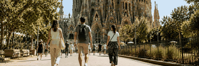 Visitors wearing appropriate summer clothing while visiting Sagrada Família in Barcelona.